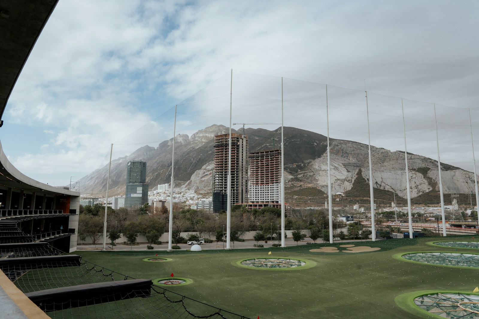 a golf course with mountains in the background