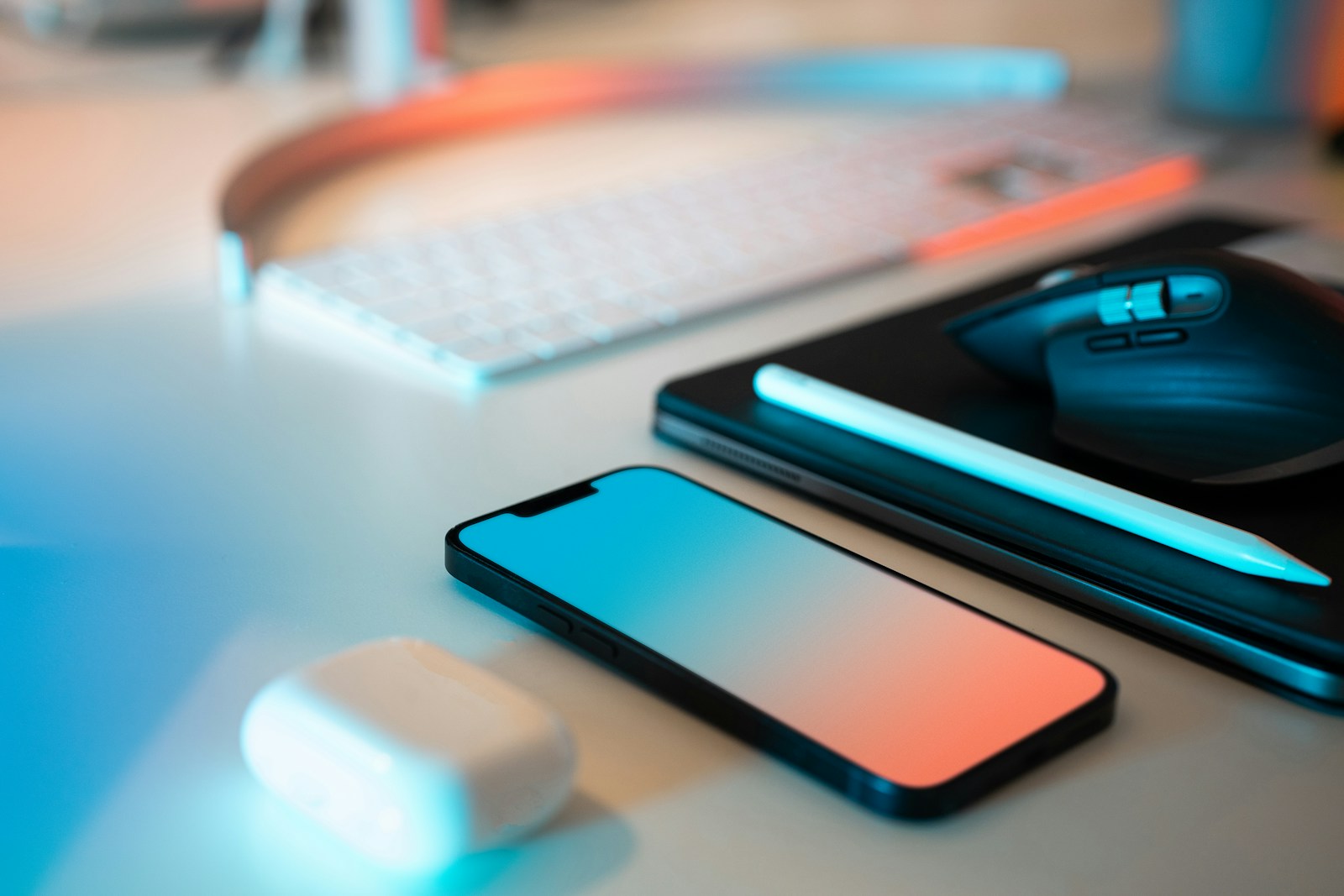 a mouse, keyboard, and cell phone sitting on a desk