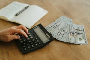 A Person Holding Black Desk Calculator