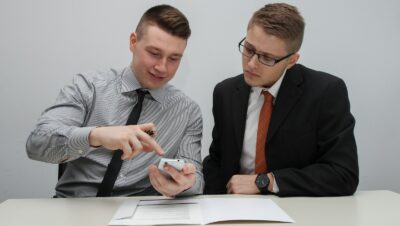 two man watching smartphone