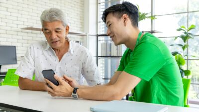 a man and a woman looking at a cell phone