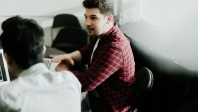 a man sitting in front of a laptop computer