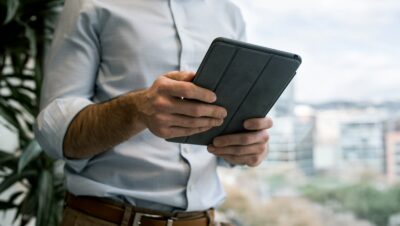 person holding black smart cover during daytime