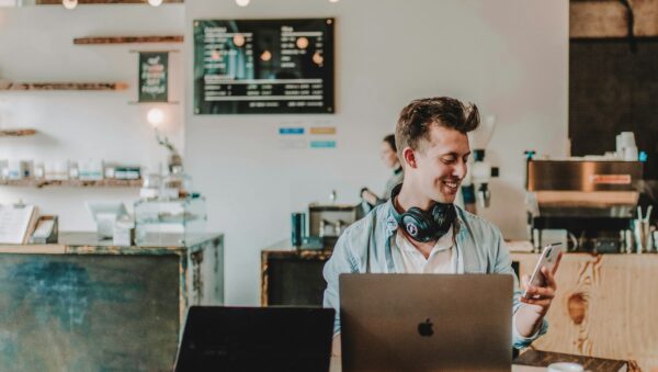 man using smartphone smiling