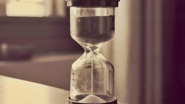 An hourglass counts down time.